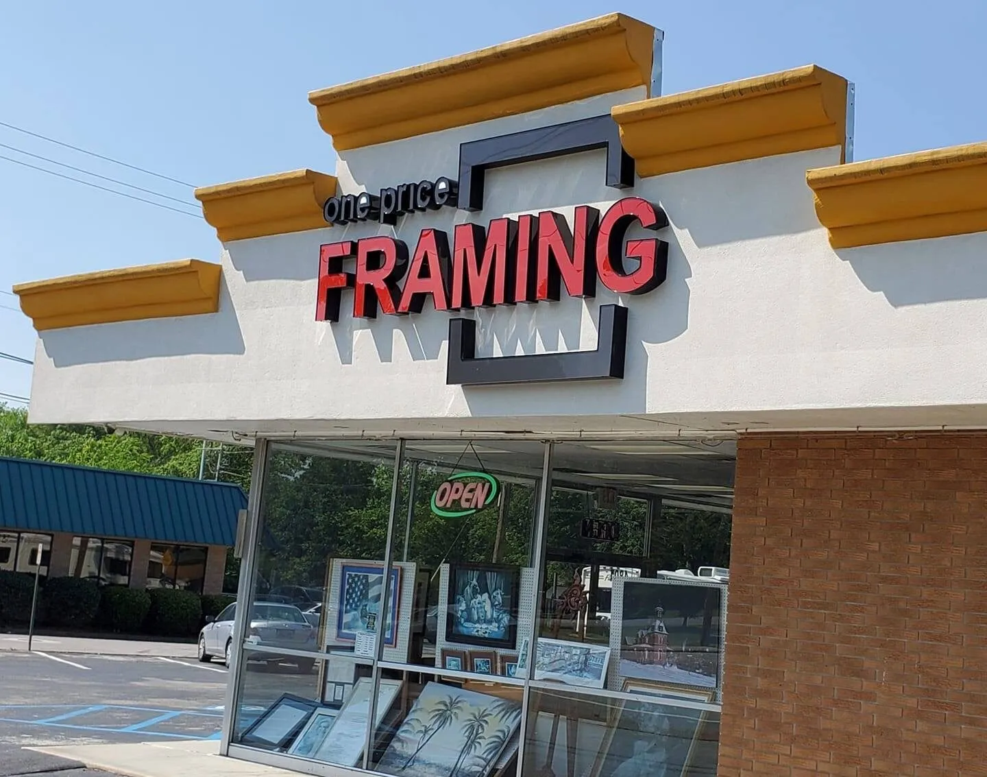 The One Price Framing storefront on Brainerd Road in Chattanooga, with its red sign and OPEN light